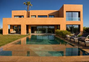 a house with a swimming pool in front of it at Villa Émeraude 5 Ch in Marrakesh