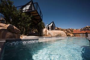 a large swimming pool in a backyard with a house at Primario Hotel Boutique in Ensenada