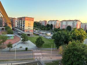a view of a city with buildings and a parking lot at Humanitas & Forum - CASA TUA Housing in Rozzano