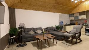 a living room with a couch and a table at Sadeel chalet in Kerak