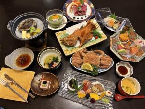 a table with many plates of food on it at Ryokan Ichinomatsu in Hakodate +120 photos