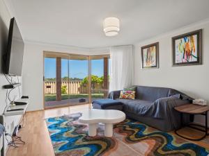 a living room with a couch and a table at Ocean Reef Marina by the Sea 4BR plus Study plus in Perth