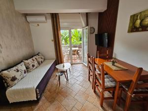a living room with a couch and a table and a dining room at Apartments Popovic 2 in Kotor
