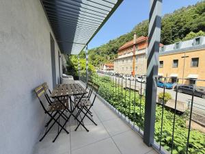 a balcony with a table and chairs and a view of a street at Gerês River Terrace in Geres