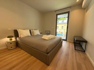 a bedroom with a bed and a large window at Gerês River Terrace in Geres +50 photos