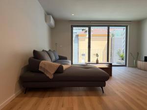 a couch in a living room with a large window at Gerês River Terrace in Geres