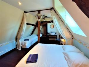 a bedroom with two beds in a attic at La Roselière 6 couchages in Sainte-Colombe