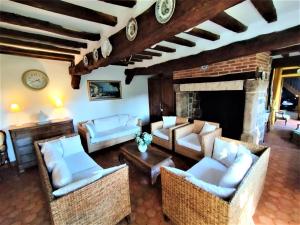a living room with couches and a fireplace at La Roselière 6 couchages in Sainte-Colombe