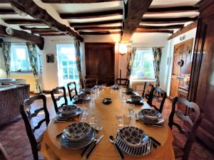 a dining room table with plates and glasses on it at La Roselière 6 couchages in Sainte-Colombe