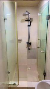 a bathroom with a glass shower with a sink at Trendy Inn limited in Lagos +59 photos