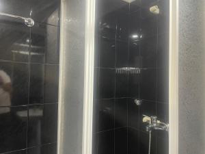 a bathroom with a shower with a black tiled at Casa do Pai in Vila Praia de Âncora +43 photos