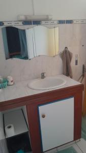 a bathroom with a sink and a mirror at Bungalow vue sur mer in Sainte-Anne