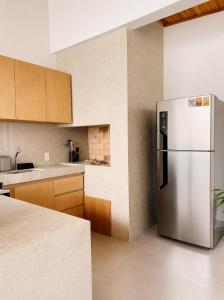 a kitchen with a stainless steel refrigerator at Villa Rita - Preá in Prea