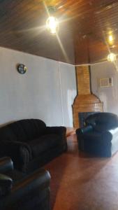 a living room with a couch and a fireplace at Rincón de Esperanza in Puerto Esperanza