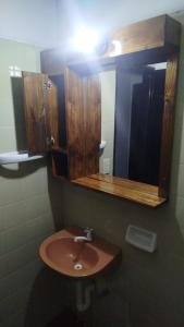 a bathroom with a sink and a mirror at Rincón de Esperanza in Puerto Esperanza