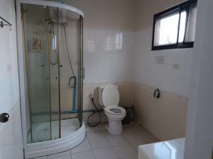a bathroom with a glass shower and a toilet at jomtien 5BR villa in Pattaya South