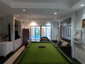 a living room with a green pool table at jomtien 5BR villa in Pattaya South