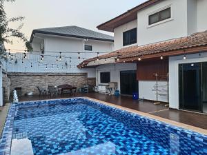 a swimming pool in the backyard of a house at jomtien 5BR villa in Pattaya South