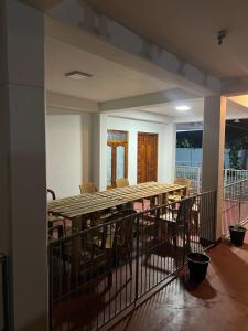 a balcony with a wooden table and chairs at lagoon holiday villa Jaffna in Tavadi