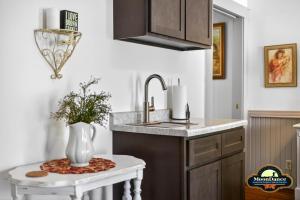 a kitchen with a sink and a vase on a table at Nashville Suite 1 in Nashville