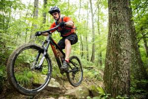 a man riding a bike on a trail in the woods at Nashville Suite 1 in Nashville