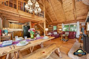 a dining room and living room in a log cabin at Dogwood Hills in Nashville