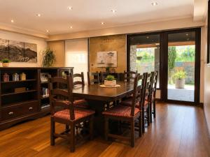 a dining room with a wooden table and chairs at Vistapeña in Piedrahita
