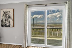 a room with a window with a view of the ocean at Sunny Shack in Black Point Landing +43 photos