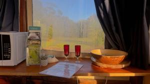 a table with two wine glasses and a microwave at Shipwrecked Oasis Ocean Bay Getaway PL in Fingal +46 photos
