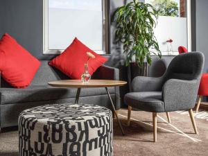 a living room with a couch and chairs and a table at ibis Coventry Centre in Coventry