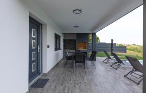 a kitchen and dining area of a house with chairs at Amazing Home In Banfi in Štrigova