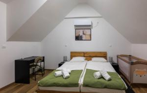 a bedroom with a bed with a green blanket at Amazing Home In Banfi in Štrigova