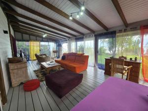 a living room with a couch and a table at Villa Fareatai in Ataiti