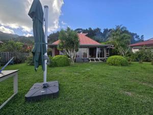 a closed umbrella in the yard of a house at Villa Fareatai in Ataiti