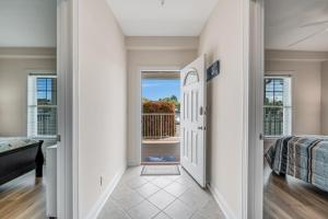 a hallway with a door leading to a bedroom at Sunset Bay Villa 110 - Hawks Nest in Chincoteague