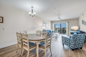 a dining room and living room with a table and chairs at Sunset Bay Villa 110 - Hawks Nest in Chincoteague