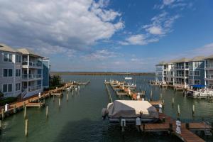 a marina with houses and boats in the water at Sunset Bay Villa 209 in Chincoteague