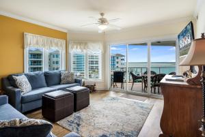 a living room with a blue couch and a view of the ocean at Sunset Bay Villa 216 in Chincoteague