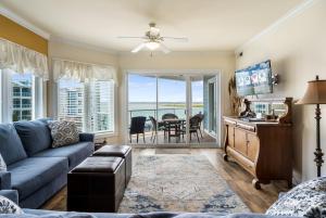 a living room with a blue couch and a table at Sunset Bay Villa 216 in Chincoteague