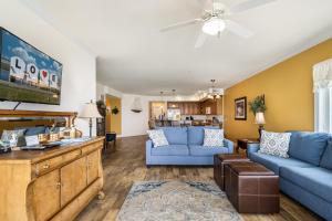 a living room with two blue couches and a couch at Sunset Bay Villa 216 in Chincoteague +33 photos