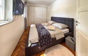 a bed in a small room with a television at Lovely Home In Podhum With House A Panoramic View in Podhum