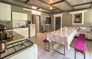 a kitchen with a table with purple chairs in it at Lovely Home In Podhum With House A Panoramic View in Podhum