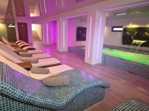 a room with a row of chairs and purple lights at Casa Cristian Wellness & Spa in Haţeg