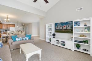 a living room with a couch and a tv at Sunset Bay Villa 309 - Changes in Latitude in Chincoteague