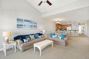 a living room with two couches and a kitchen at Sunset Bay Villa 309 - Changes in Latitude in Chincoteague