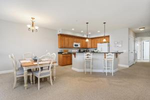 a kitchen and dining room with a table and chairs at Sunset Bay Villa 309 - Changes in Latitude in Chincoteague +31 photos