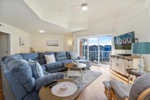 a living room with a blue couch and a table at Sunset Bay Villa 313 - By the Bay in Chincoteague