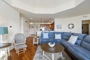 a living room with a blue couch and a table at Sunset Bay Villa 313 - By the Bay in Chincoteague