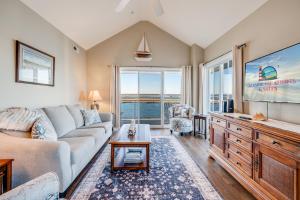 a living room with a couch and a tv at Sunset Bay Villa 319 - Bella Vista in Chincoteague