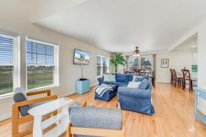 a living room with blue couches and a table at The Baywatch Bungalow in Greenbackville +48 photos